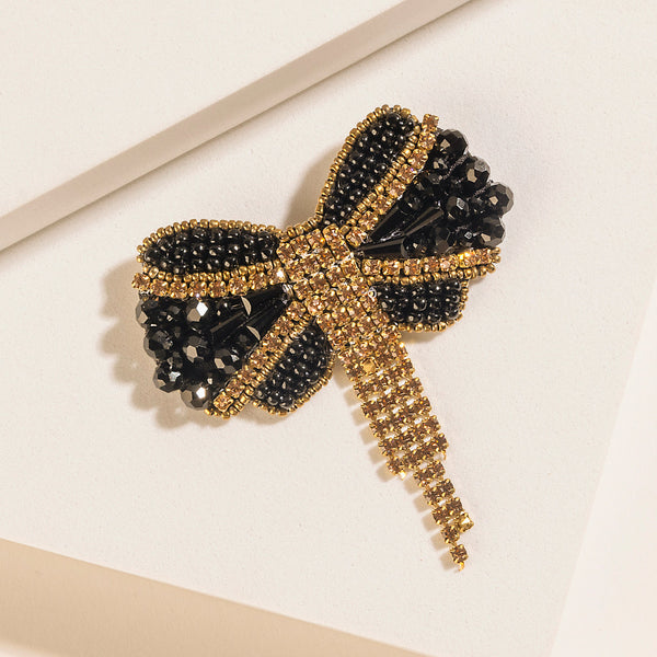 Myra Evening Grace Bow Brooch in Gilded Gold - Myra USA