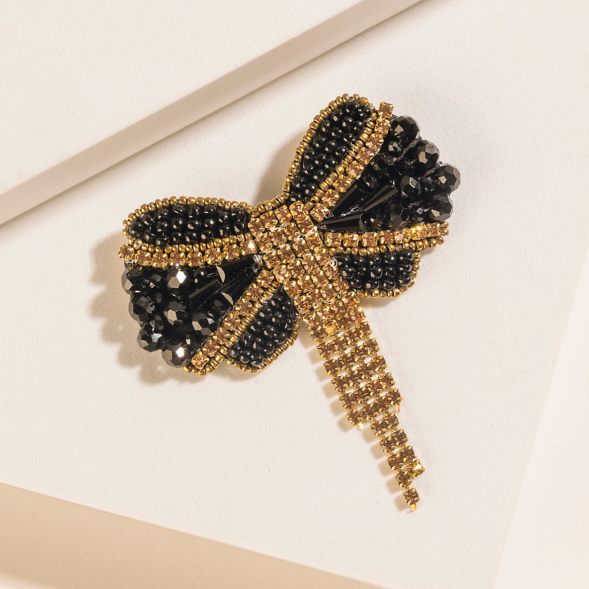 Myra Evening Grace Bow Brooch in Gilded Gold - Myra USA