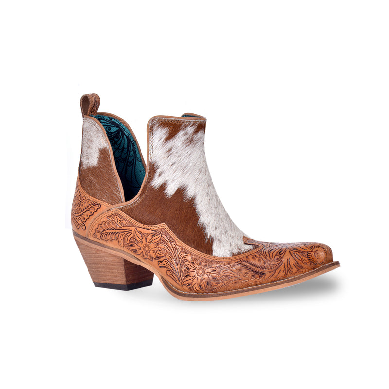 Brown and white cowgirl booties with tooled leather in floral pattern