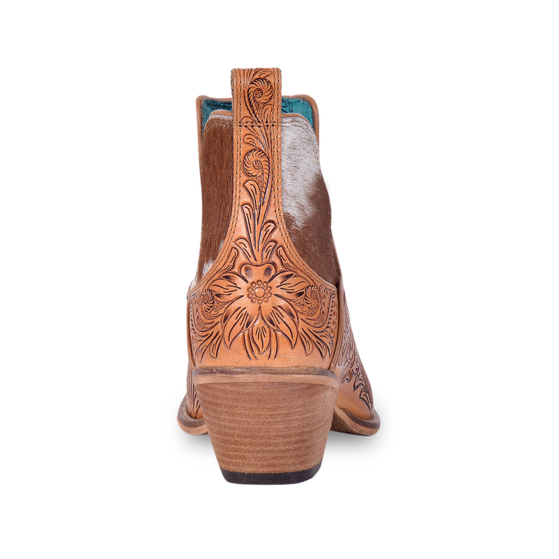 Brown and white cowgirl booties with tooled leather in floral pattern