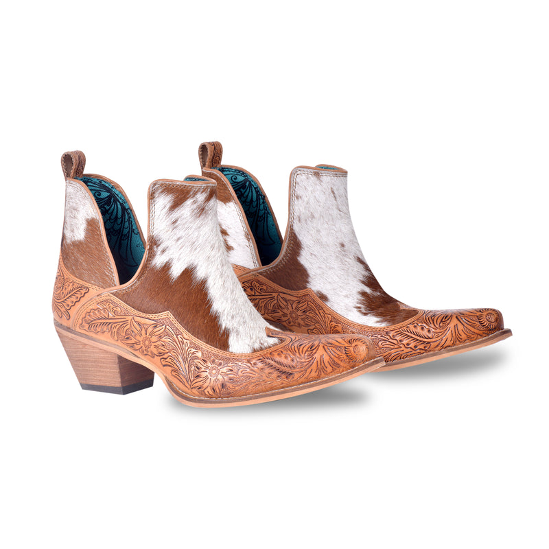 Brown and white cowgirl booties with tooled leather in floral pattern