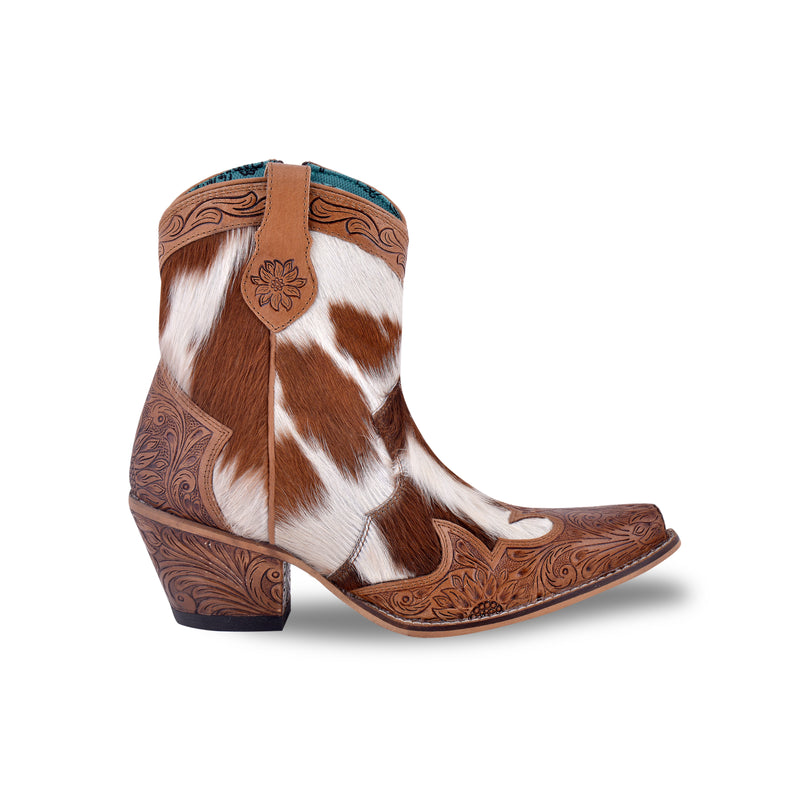 White and brown cowgirl boots with embossed floral patterns on the toe and heel areas