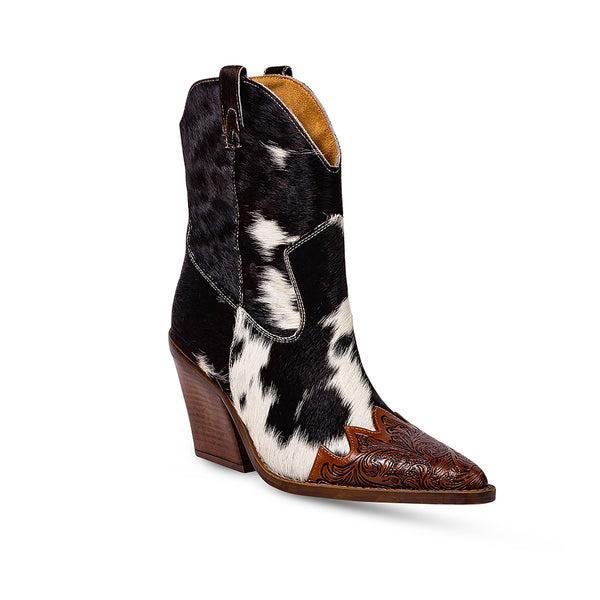 Cowgirl boots with a pointed toe and a mid-height heel featuring black and white cowhide leather