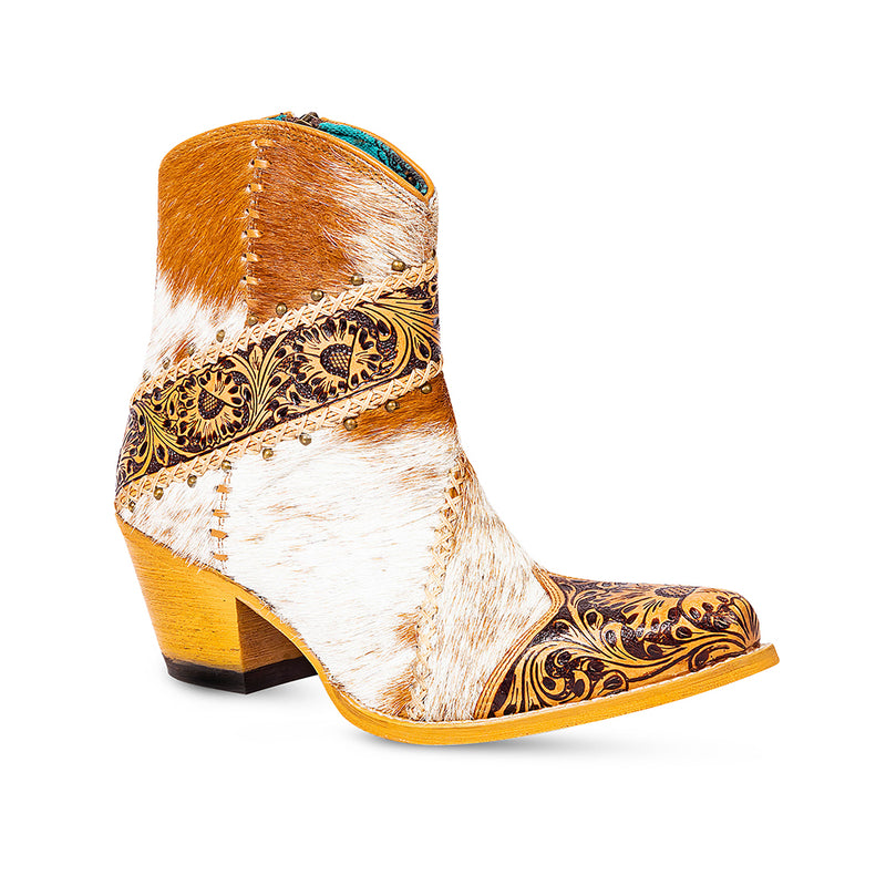 Cowgirl boots with golden floral patterns embossed on the front