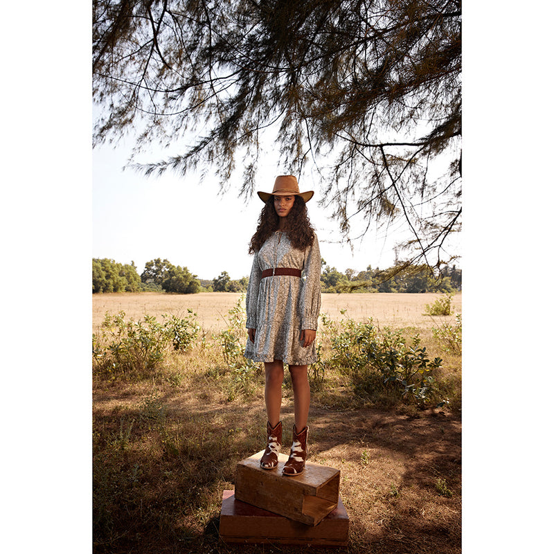 Brown and white cowhide & hand tooled western boots with slightly elevated heels and pointed toes