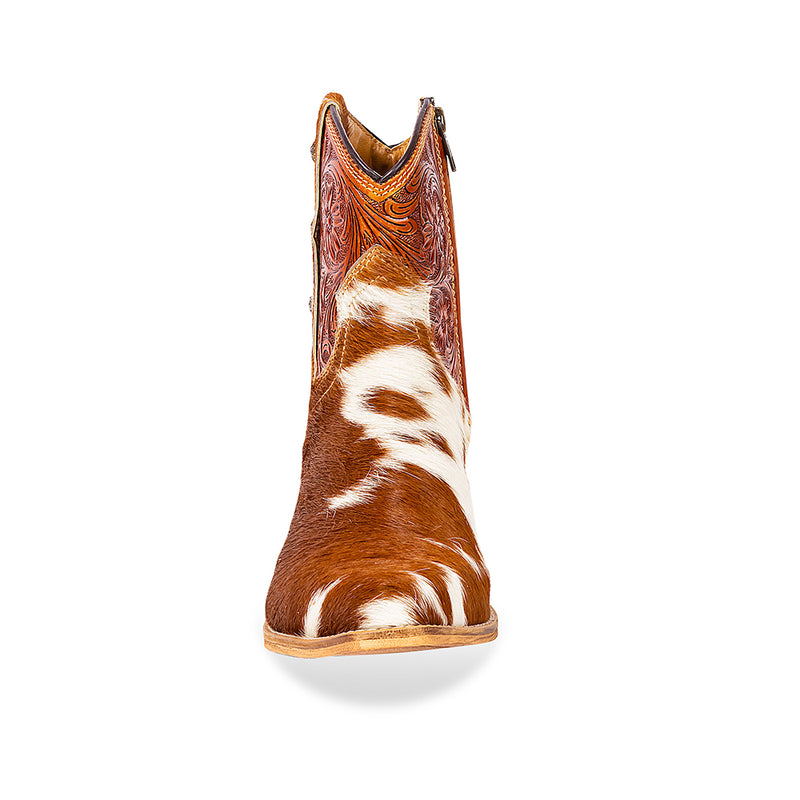 Brown and white cowhide & hand tooled western boots with slightly elevated heels and pointed toes