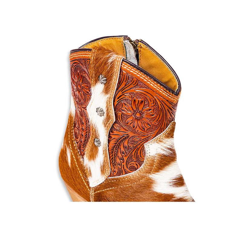 Brown and white cowhide & hand tooled western boots with slightly elevated heels and pointed toes