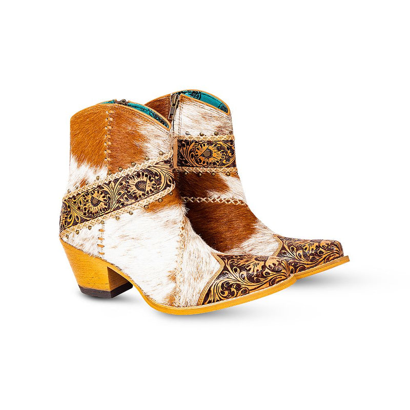 Cowgirl boots with golden floral patterns embossed on the front