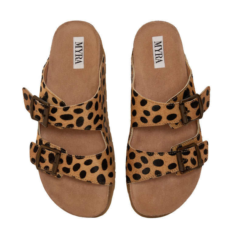 Handtooled leather sandals with a leopard print design and two straps across the top with adjustable buckles