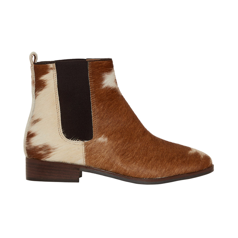 cowgirl boots in brown and white color with dark elastic side panels