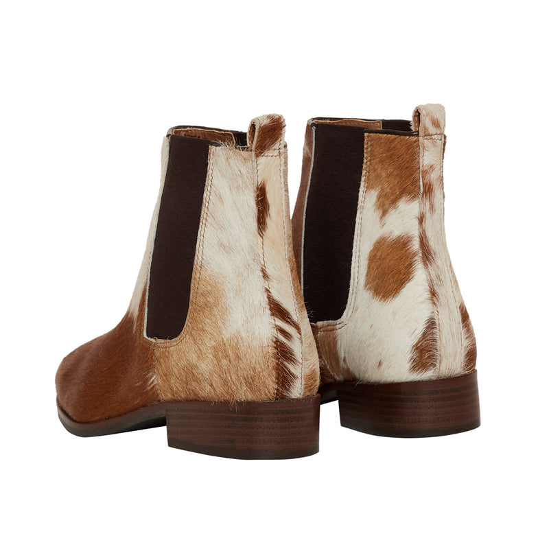 cowgirl boots in brown and white color with dark elastic side panels