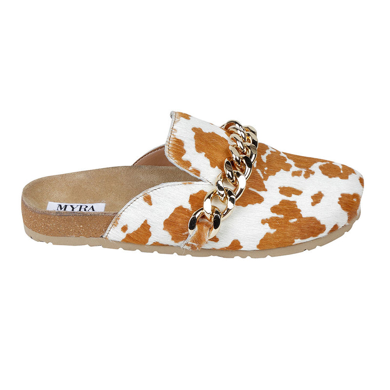 Brown and white cowhide slip-on slippers with golden chain detailing on the upper