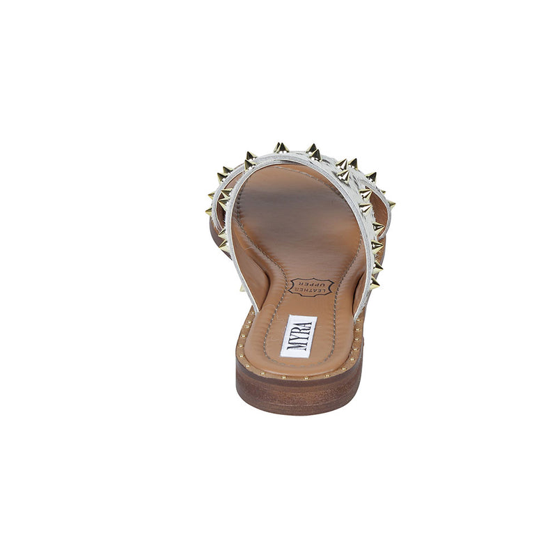 Trendy western sandals with white straps adorned with small, metallic spike embellishments