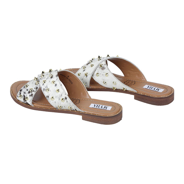 Trendy western sandals with white straps adorned with small, metallic spike embellishments