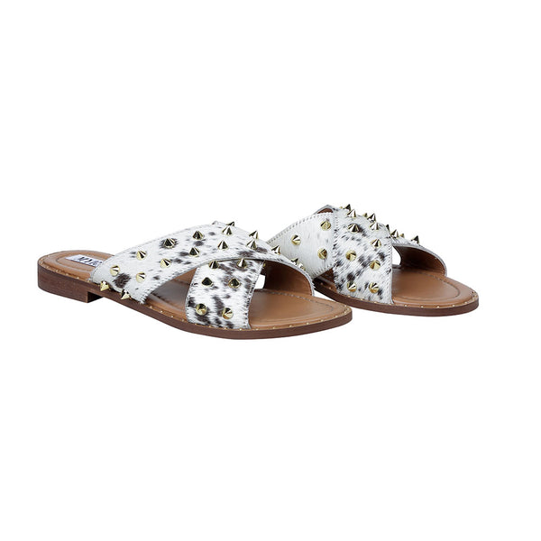 Trendy western sandals with white straps adorned with small, metallic spike embellishments