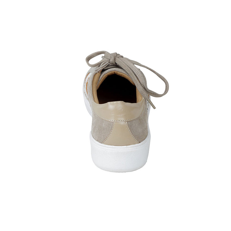 White low-top and lace-up western sneakers with small shiny studs and brown patches