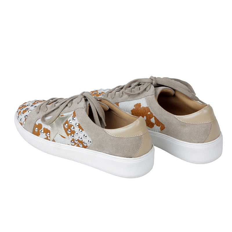 White low-top and lace-up western sneakers with small shiny studs and brown patches