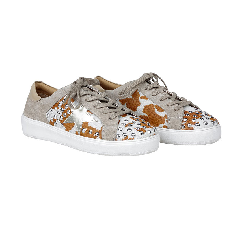 White low-top and lace-up western sneakers with small shiny studs and brown patches