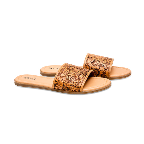 Brown tooled leather sandals with an intricate floral pattern etched into the surface