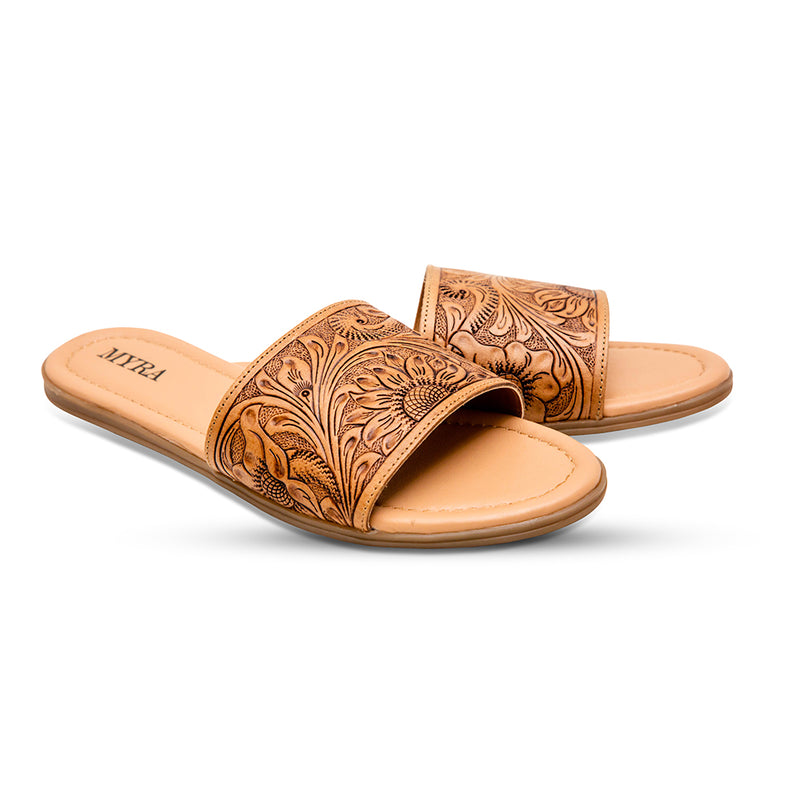 Brown tooled leather sandals with an intricate floral pattern etched into the surface