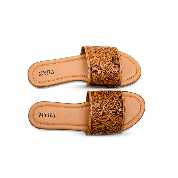 Brown tooled leather sandals with an intricate floral pattern etched into the surface