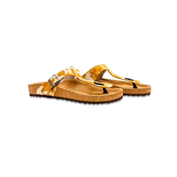 Handtooled sandals with a cork footbed and a rubber sole. Brown and white straps made with hairon leather