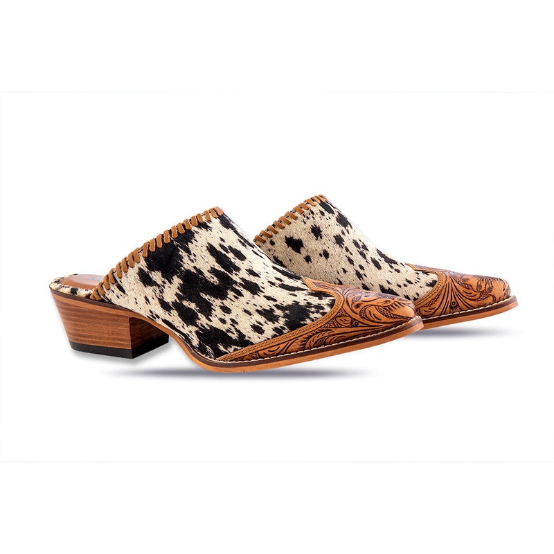 Handtooled western mules with pointed toe and black and white cowhide