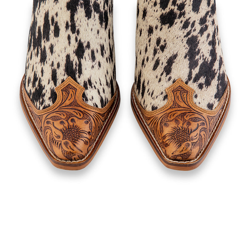 Handtooled western mules with pointed toe and black and white cowhide